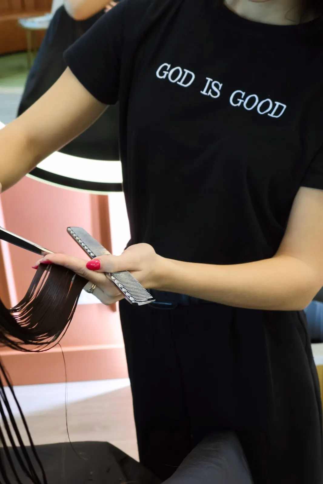 Mademoiselle stylist cutting hair with comb and scissors