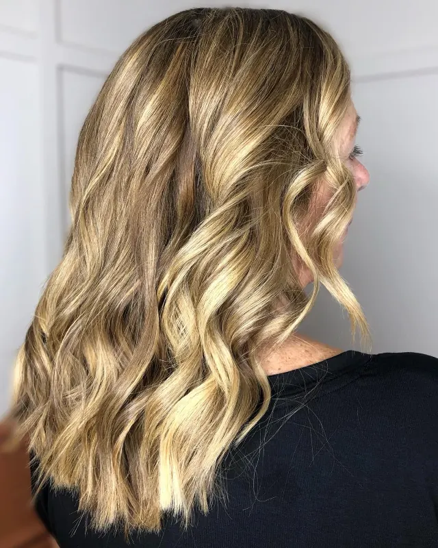 Long, voluminous blonde hair with seamless waves