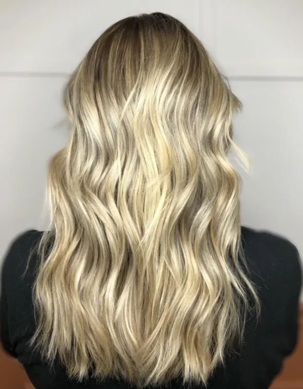 Polished blonde waves styled with movement